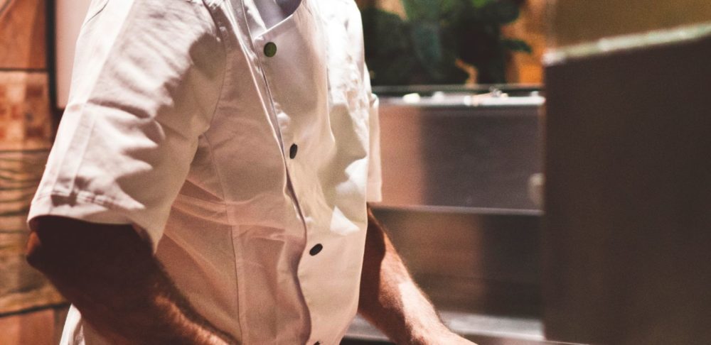 A man making a Neapolitan pizza in Italy.