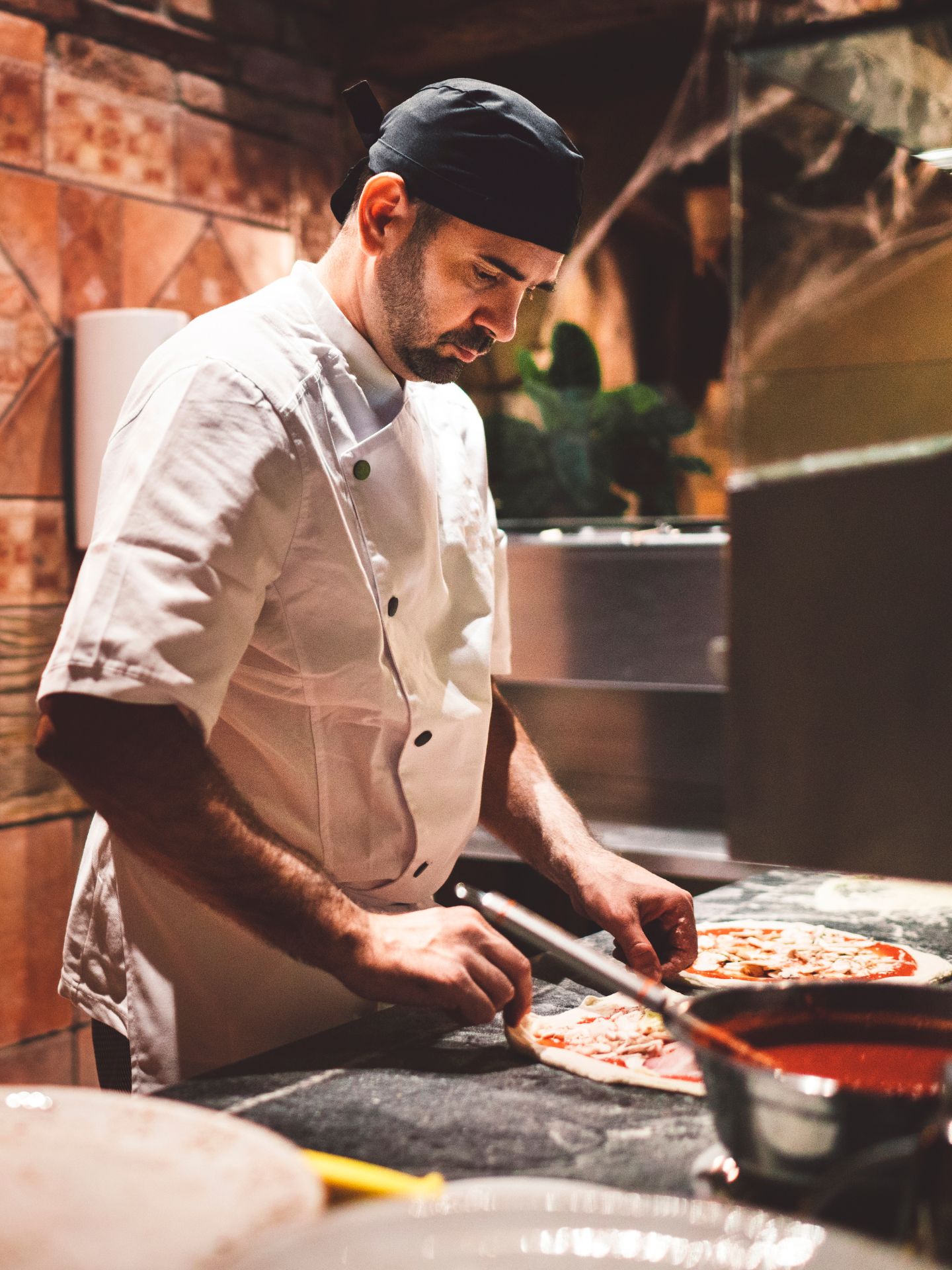 A man making a Neapolitan pizza in Italy.