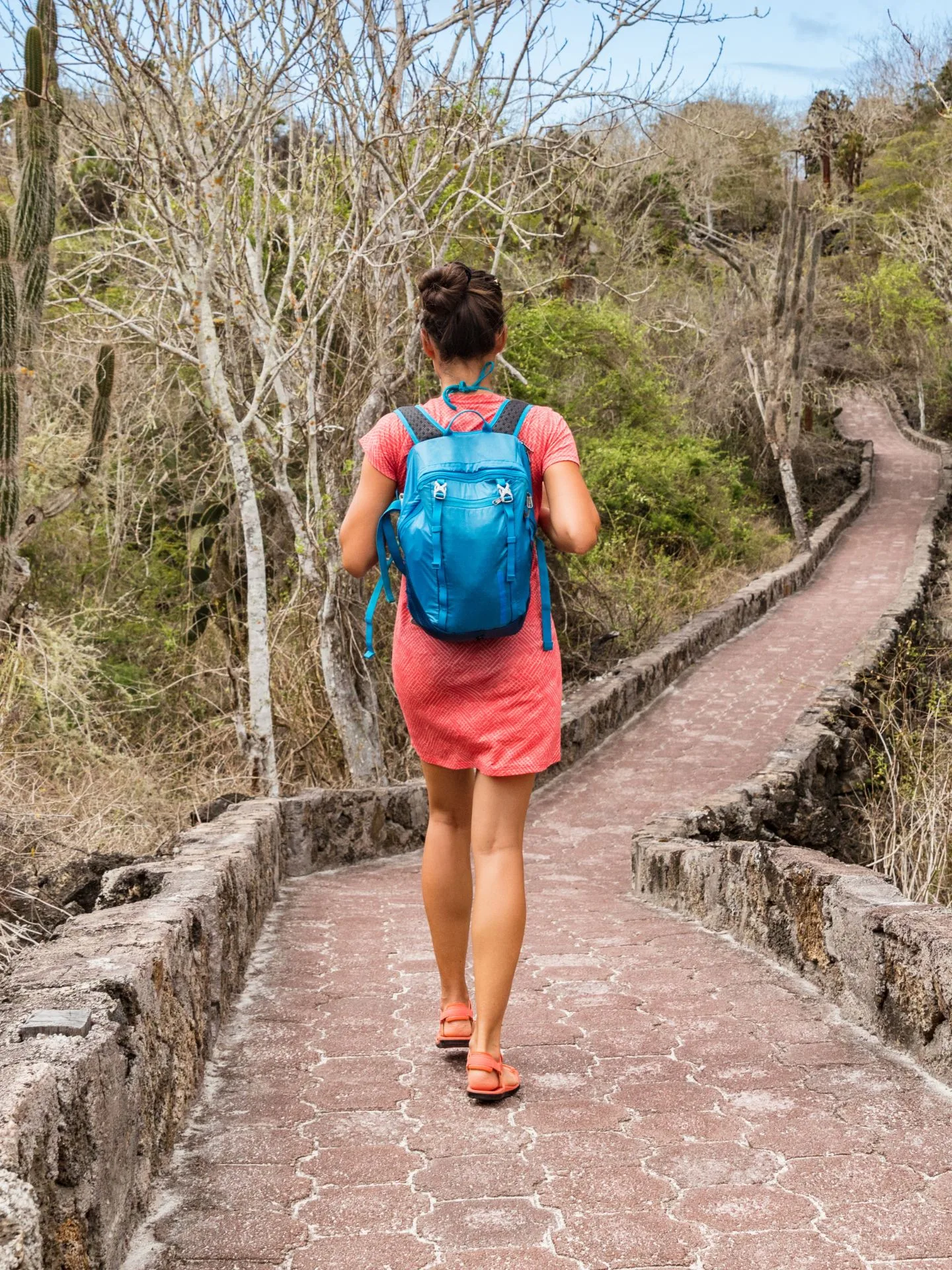 Woman walking on path in Galapagos Islands.